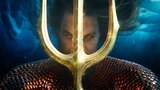 Aquaman’s eyes glow gold as he stares closely at his golden trident.