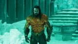 Aquaman glares menacingly in his gold and green suit.