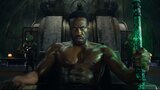 Black Manta’s eyes glow green as he holds the Black Trident in his left hand.