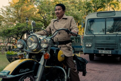The General sits on a black and yellow motorcycle.