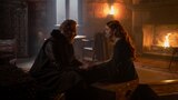 Ser Otto Hightower and Queen Alicent Hightower sit on trunks facing one another, holding hands. 