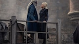 Lord Corlys Velaryon and Princess Rhaenys Targaryen stand on a dock, facing one another.