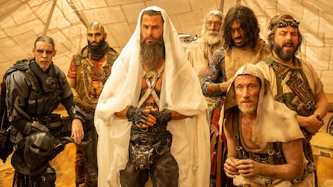 Dementus and six members of the Biker Horde, including The Octoboss, Fang, The History Man, The Organic Mechanic, and Smeg, stand in a tent.  