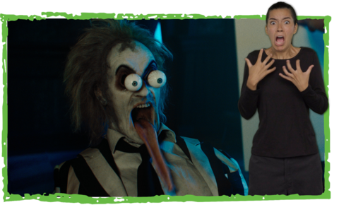 Beetlejuice cartoonishly screams with large bulging eyes, mouth wide open, and a ridiculously long tongue hanging out. ASL performer Sophia Morales stands in the bottom right and signs “screaming.” A badge in the upper-left corner reads “With ASL” and shows the symbol for ASL.