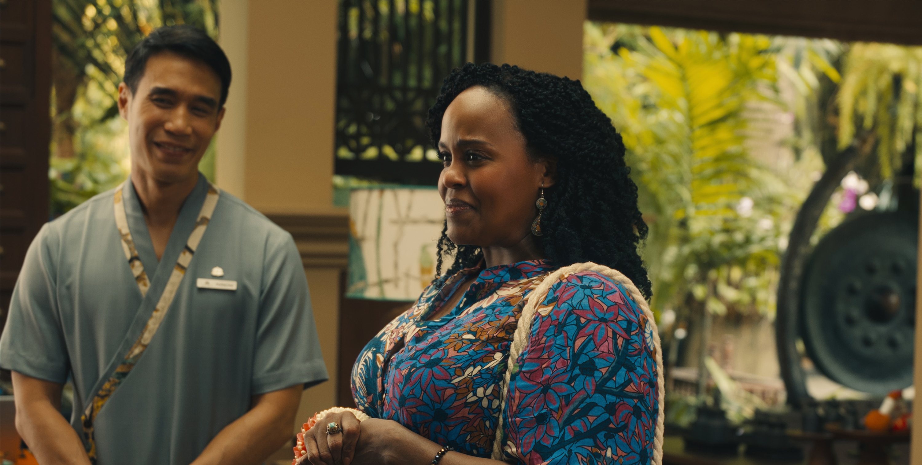 Belinda Lindsey (Natasha Rothwell) and Pornchai (Dom Hetrakul) smile at something out of frame.
