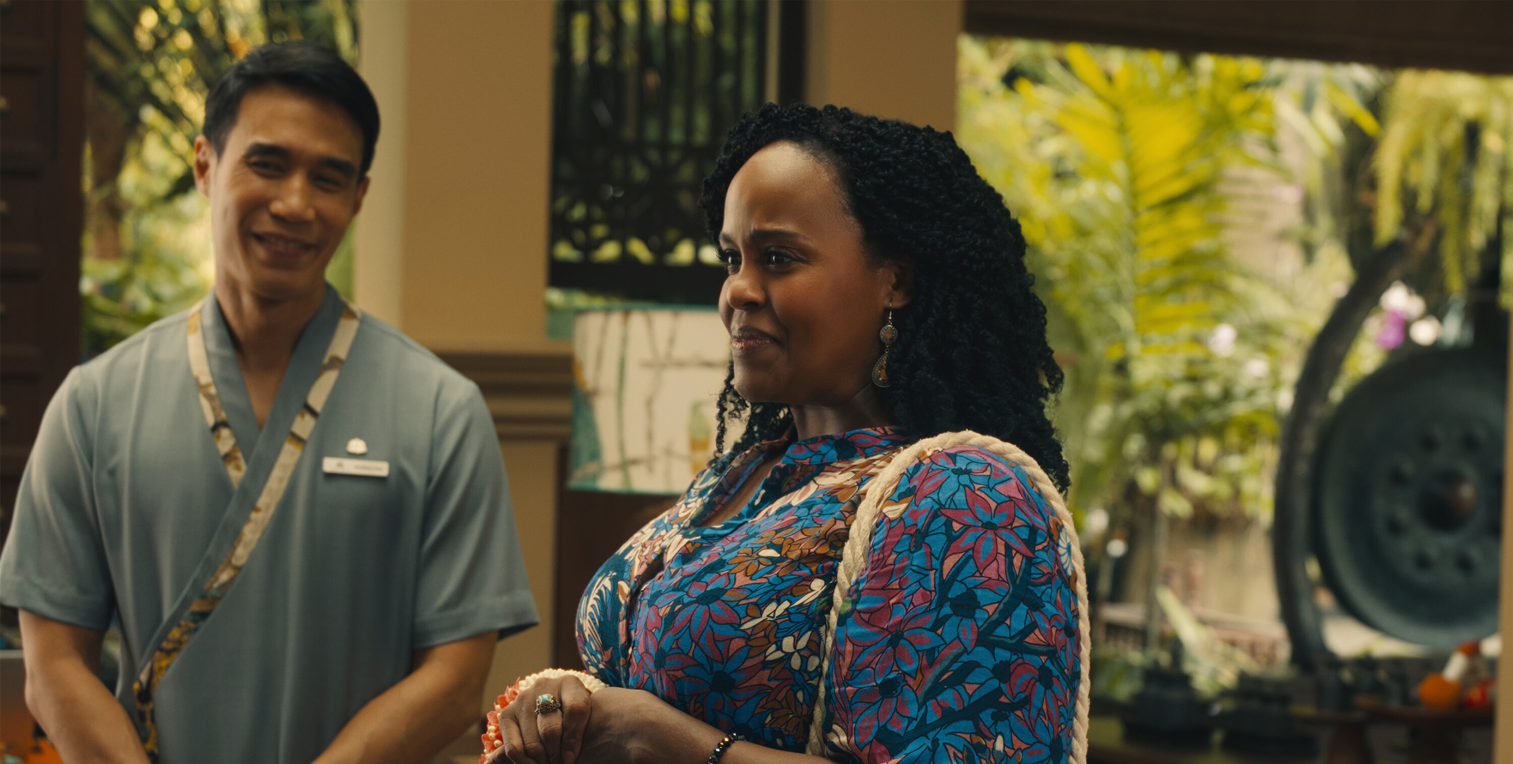 Belinda Lindsey (Natasha Rothwell) and Pornchai (Dom Hetrakul) smile at something out of frame. 