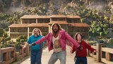 Steve, Garrett, and Henry stand on a long bridge, a large three-story building with dozens of windows behind them. They all look at something out of frame with their mouths agape. Garrett stands in the middle and holds out his arms as if to protect Steve and Henry who stand on either side of him.