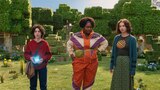 Henry, Dawn, and Natalie stand in a park-like setting. Henry holds a glowing blue cube and looks at something out of frame. Dawn and Natalie look at each other with unsure expressions.
