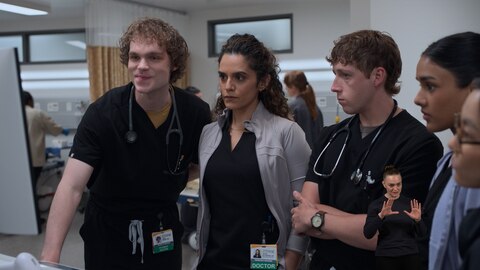 James, Dr. Baran Al-Hashimi, Dennis Whitaker, Victoria Javadi, and Joy stand in a semicircle, looking at the monitor on a mobile workstation. On the right side of the image, ASL performer Amelia Hensley signs "image." 