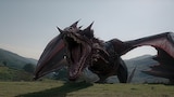 Daemon Targaryen’s dragon Caraxes stands in a grass-covered valley, neck extended and mouth wide open in a full-throated roar.